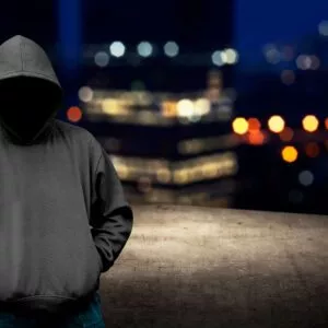 Faceless man in hood on the rooftop