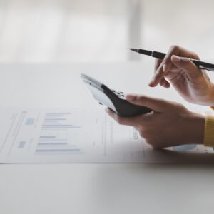 Businessman using a calculator to calculate numbers on a company
