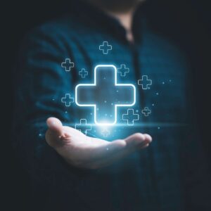 Businessman holding virtual blue plus sign for positive thinking